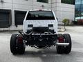 A 2024 Ford F-550 viewed from the rear showcasing its chassis and dual rear tires without a truck bed installed