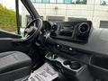 Interior of a 2020 Mercedes-Benz Sprinter showing the dashboard steering wheel and center console with cup holders and a digital display
