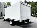 A white 2021 Ford E-450 box truck with a flatbed rear and no visible branding