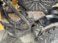2014 Vermeer Corporation Sweep Stump Cutter with a prominent engine cover large tires and various hydraulic hoses and wiring visible on the machine's frame