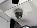 A dome security camera installed on the ceiling of a vehicle