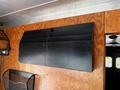 A black wall-mounted organizer with multiple slots for holding papers or documents