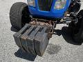 A 2018 New Holland Boomer 45 tractor with a blue body featuring a front weight block secured by bolts and two large tires visible on either side