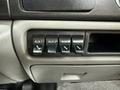 Close-up of the interior dashboard of a 2006 Ford F-450 showing four auxiliary switch buttons labeled AUX 1 AUX 2 AUX 3 and AUX 4