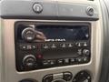 Dashboard controls of a 2012 GMC Canyon featuring audio system buttons and a digital display for MP3 and radio functions