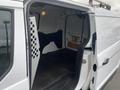 Interior view of a 2017 Ford Transit Connect van showing an empty cargo area with a light on and dotted paneling on one side