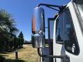 A 2018 International DuraStar truck featuring a chrome side mirror with an orange indicator light mounted on the driver's side