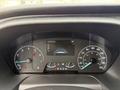 Dashboard of a 2023 Ford Transit showing speedometer tachometer and digital display with mileage and temperature