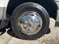 Close-up of a shiny wheel with a polished chrome hubcap and rugged tire tread on a 2017 Chevrolet Express