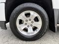 A silver wheel with a Chevrolet emblem and black tire labeled Destination A/T on a 2018 Chevrolet Silverado 1500