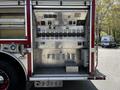 A 2006 Emergency One Fire Truck featuring a compartment with various gauges switches and control panels for emergency operations
