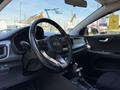 Interior view of a 2018 Kia Rio5 showing the steering wheel dashboard and gear shift