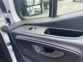 Close-up of the interior door panel of a 2024 Mercedes-Benz Sprinter featuring a door handle and power window controls