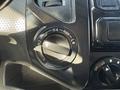The interior controls of a 2015 Toyota Tacoma featuring a dial for four-wheel drive settings with labeled positions H4 H2 L4 and a separate knob for off and low settings