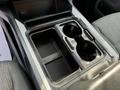 A console cup holder insert for a 2023 Ford F-550 featuring two circular cup holders and a rectangular storage space