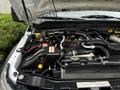 Engine compartment of a 2011 Ford F-550 featuring a large engine with various hoses wires and components visible