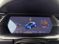Dashboard display of a 2020 Tesla Model X showing a blue car graphic with details about battery charge distance and energy consumption statistics