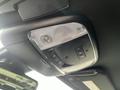 Interior overhead console of a 2022 Dodge Charger featuring a light and control buttons for various functions