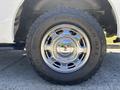 A close-up of a chrome wheel from a 2016 Ford F-150 featuring a black tire labeled Discoverer AT3