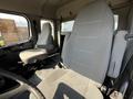Interior of a 2004 Freightliner M2 showing two gray fabric seats positioned side by side with no visible occupants