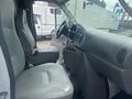 Interior of a 2004 Ford Econoline showing two front seats and the dashboard with steering wheel and controls