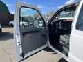 A 2013 Ford F-250 SD with an open door showing the interior featuring a steering wheel and dashboard