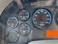 The image shows the dashboard gauge cluster of a 2015 International DuraStar 4300 featuring gauges for temperature water and oil pressure along with an RPM gauge