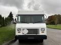 A white 2011 Ford Econoline van facing forward with a flat front and large windshield