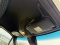The interior ceiling of a 2019 Mercedes-Benz Sprinter showing storage compartments and an overhead light