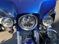 Front view of a 2017 Harley-Davidson FLHXS featuring a shiny blue finish and multiple round headlights with chrome detailing