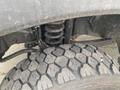Close-up of a 2017 Ford F-550's suspension system with a visible coil spring and a rugged, textured tire tread