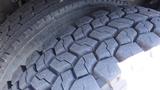 Close-up of the treads of two tires from a 2017 Freightliner M2 106 showcasing their rugged design and depth