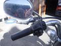 Close-up of a 2009 Harley-Davidson FLSTC motorcycle's handlebar featuring a throttle grip and mirror