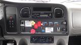 Dashboard of a 2006 Freightliner M2 106 Medium Duty truck with various controls gauges and an audio system