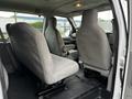 Interior view of a 2011 Ford Econoline showing two gray cloth seats positioned facing each other in the back of the van