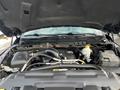 Engine compartment of a 2015 RAM 1500 showing various engine components and a battery mounted on the right side