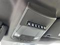 A close-up view of the overhead control panel in a 2018 Ford F-550 featuring various switches and a speaker grille