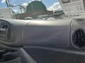 Dashboard of a 2008 Ford Econoline with a radio and air vents visible