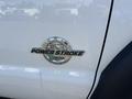 Close-up of a 2015 Ford F-450 SD badge featuring the text 67 Power Stroke B20 with a circular logo