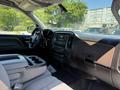 Interior view of a 2016 GMC Sierra 1500 featuring a steering wheel and dashboard with controls and a gear shift console
