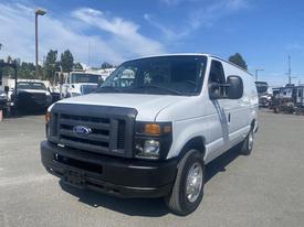 2009 Ford Econoline van in white with a black front grille and headlights parked in a lot