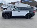 A 2021 Ford Explorer with a black and white paint scheme and black wheels positioned at a slight angle
