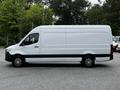 A 2019 Mercedes-Benz Sprinter van in white with a blank side panel and black trim, featuring alloy wheels and a high roof design