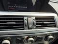 Dashboard controls of a 2004 BMW 6-Series featuring air conditioning vents and buttons for hazard lights and ventilation settings