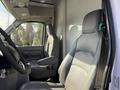 Interior of a 2012 Ford Econoline E-450 showing two gray cloth driver and passenger seats with a steering wheel and dashboard visible