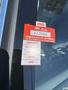 A red certificate of approval sticker on a window indicates the vehicle's inspection status and expires on the last day of May 2026