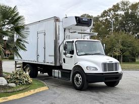 A 2018 Freightliner M2 106 truck with a white box trailer and a refrigeration unit on top facing slightly to the left