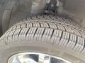 A close-up of a tire from a 2007 Chrysler PT Cruiser showing detailed tread patterns and a chrome wheel rim