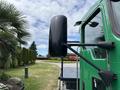 A green 2013 Kenworth T370 truck with a large black side mirror and a visible door handle