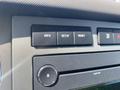 A dashboard control panel from a 2013 Ford Expedition featuring buttons for info setup and reset along with a dial for adjusting volume